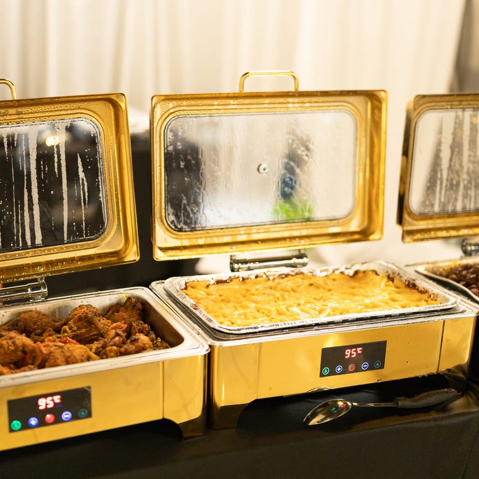 Gold chafing dishes with Haitian catering spread